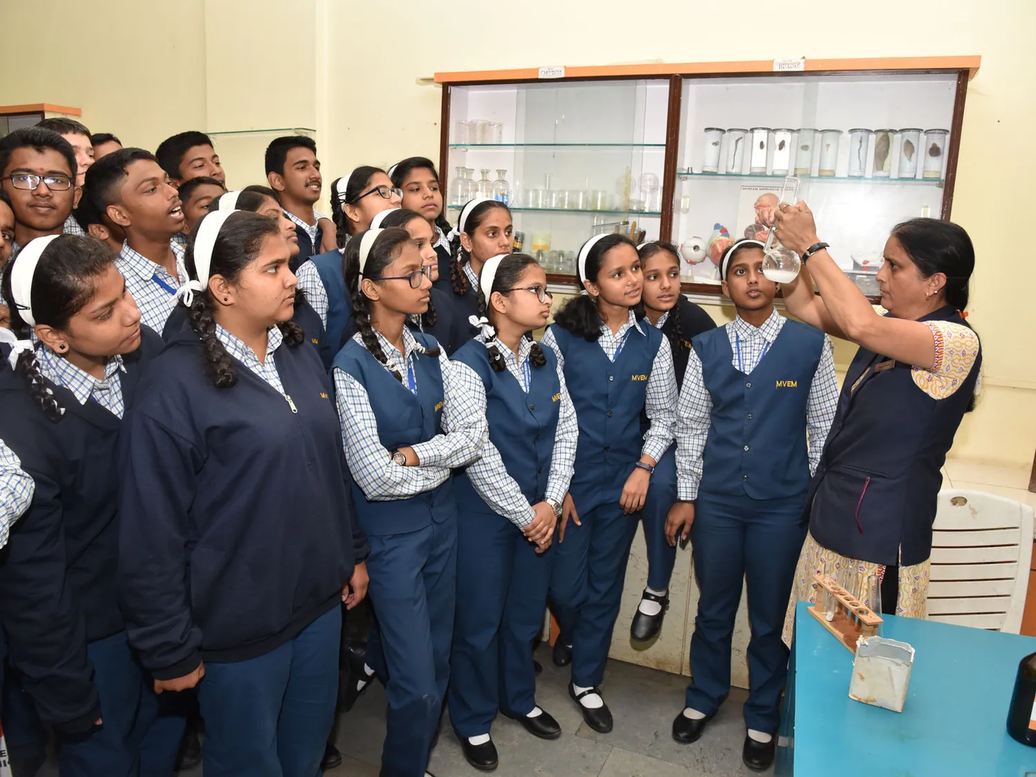 A science demonstration by the specimen cabinet