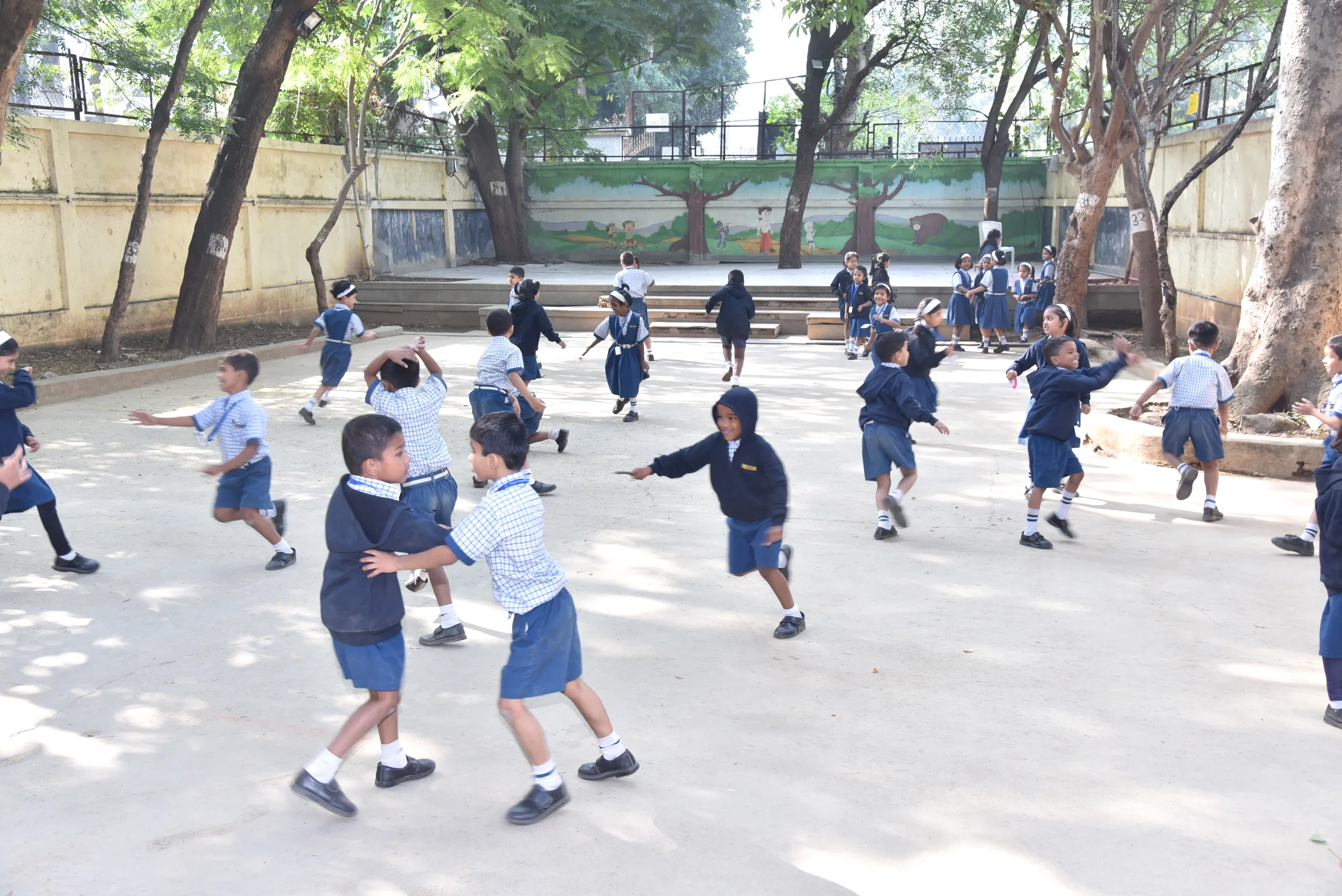 Primary children running a drill in the school yard